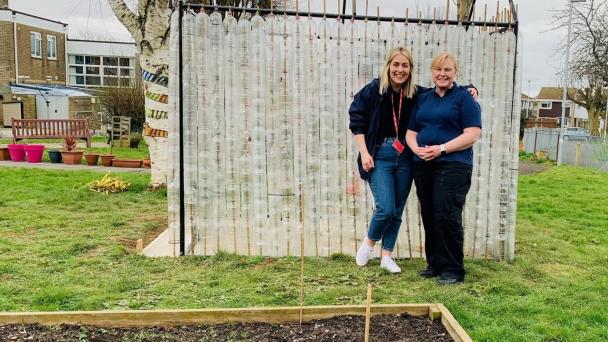 Pictured: Clement, with a community garden volunteer